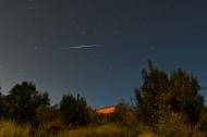 Dark and starry night sky with shooting star.