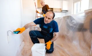 Senior home painters painting the walls in client's apartment