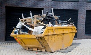 full dumpster outside of property