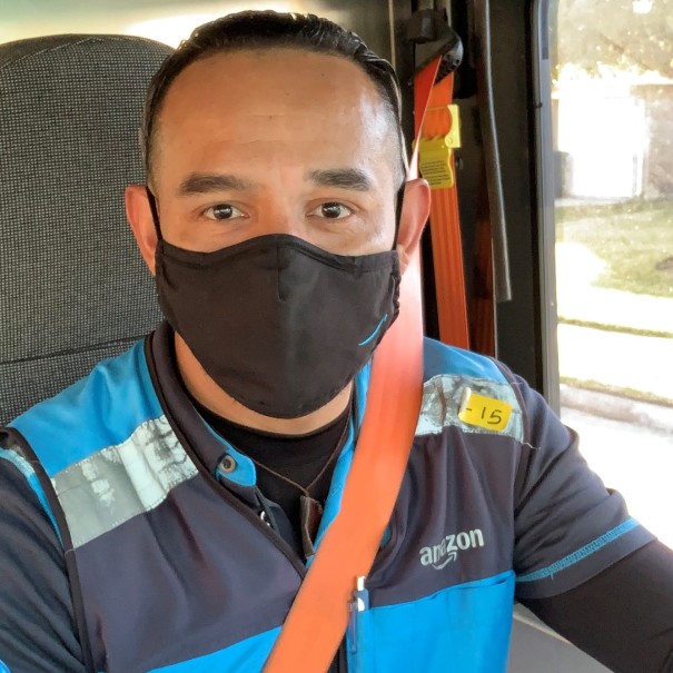 Amazon Delivery Service Provider (DSP) in their work vehicle, wearing an Amazon vest