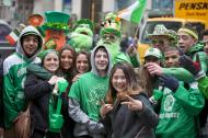 Happy people dressed in green on the street.