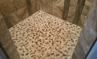 Modern shower with pebble flooring