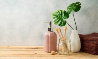 bamboo toothbrush on green eco-friendly bathroom countertop