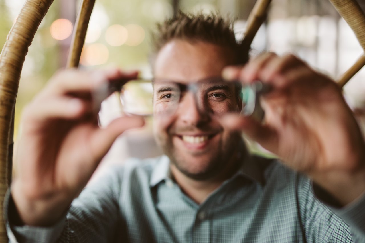 Dries holding his glasses in front of him