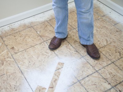 legs and feet of person standing in middle of home improvement work