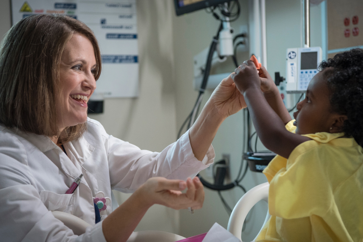 Image of Rebecca Gabriel treating a young patient