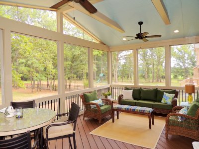 screened in porch with dining table and patio furniture set