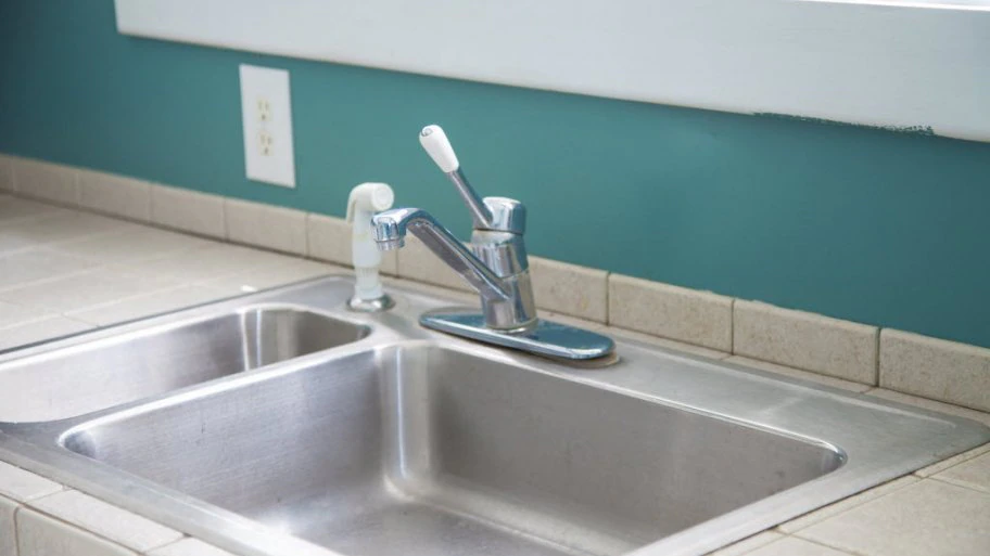 Water under the kitchen sink could be related to a leak in the faucet housing. (Photo courtesy of Katelin Kinney)