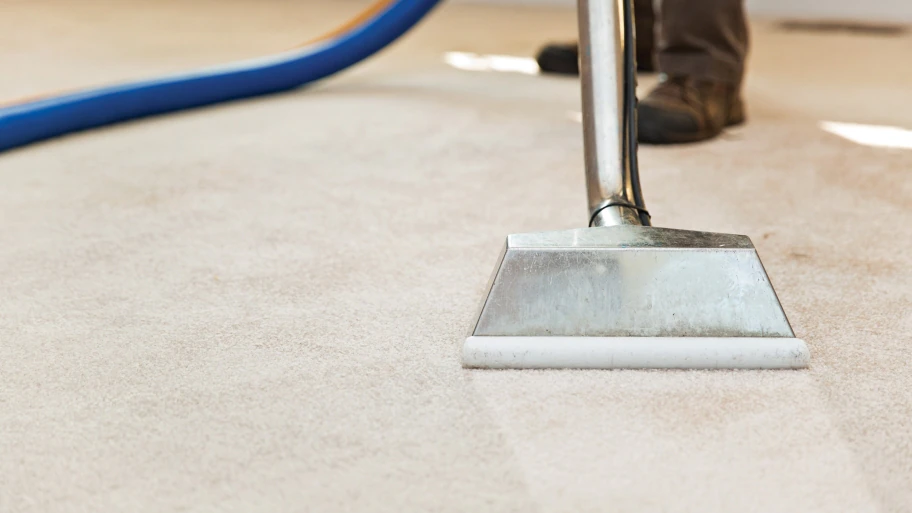 technician using carpet cleaning machine