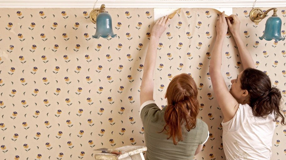 two women removing wallpaper