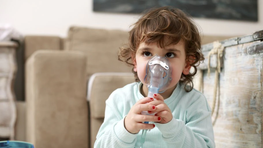 young child doing breathing treatments for asthma