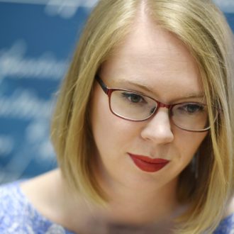 A close-up of author Maria Turtschaninoff smiling and looking downwards.