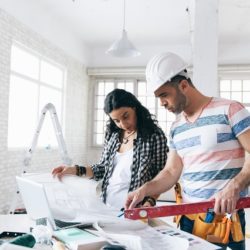 Woman managing home remodel with professional