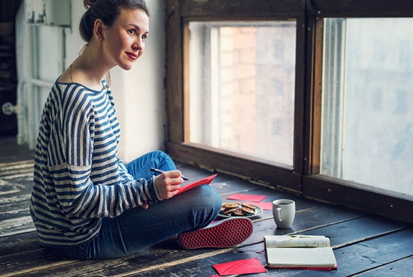 Woman reconnecting with friends and family by sending mail.