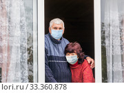 beautiful elderly couple looks out the window of a country house. Стоковое фото, фотограф Акиньшин Владимир / Фотобанк Лори