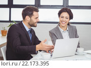 Business people discussing over laptop in meeting room. Стоковое фото, агентство Wavebreak Media / Фотобанк Лори