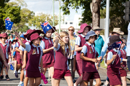 Australian school children in uniform marching in an Anzac Day parade.