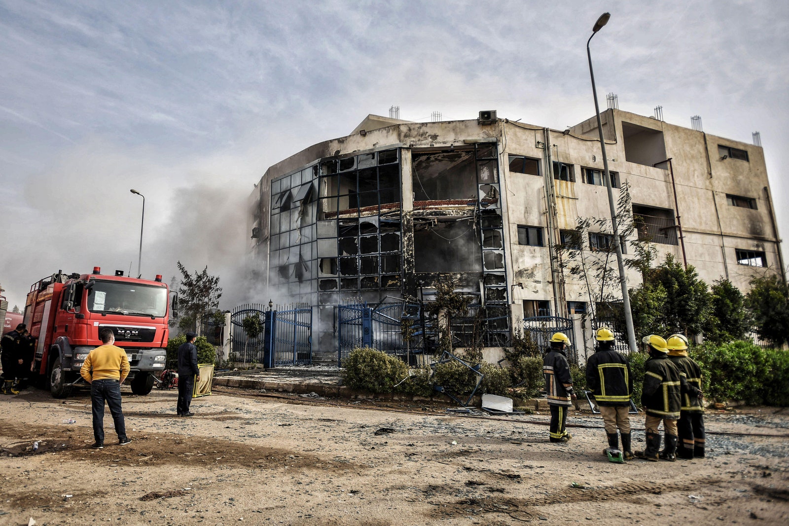 Firefighters battle flames at a fourstory garment factory in the industrial zone of Obour city north of Cairo Egypt...