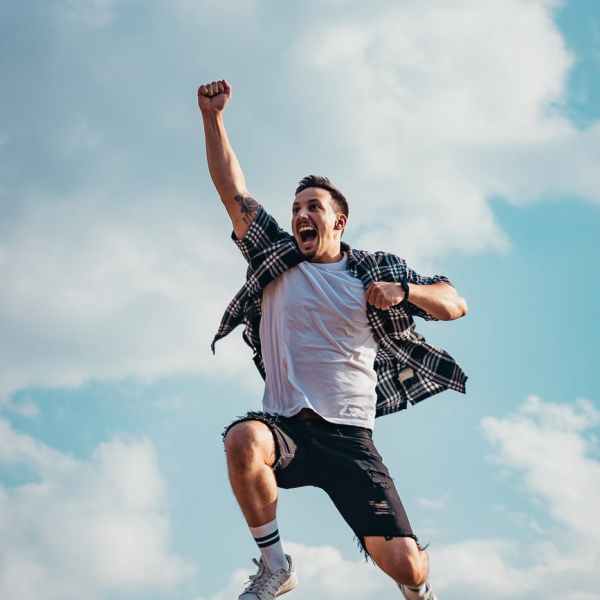 low angle photography of man jumping