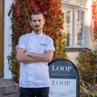 Chef Ossi Paloneva posing in front of restaurant Loop.