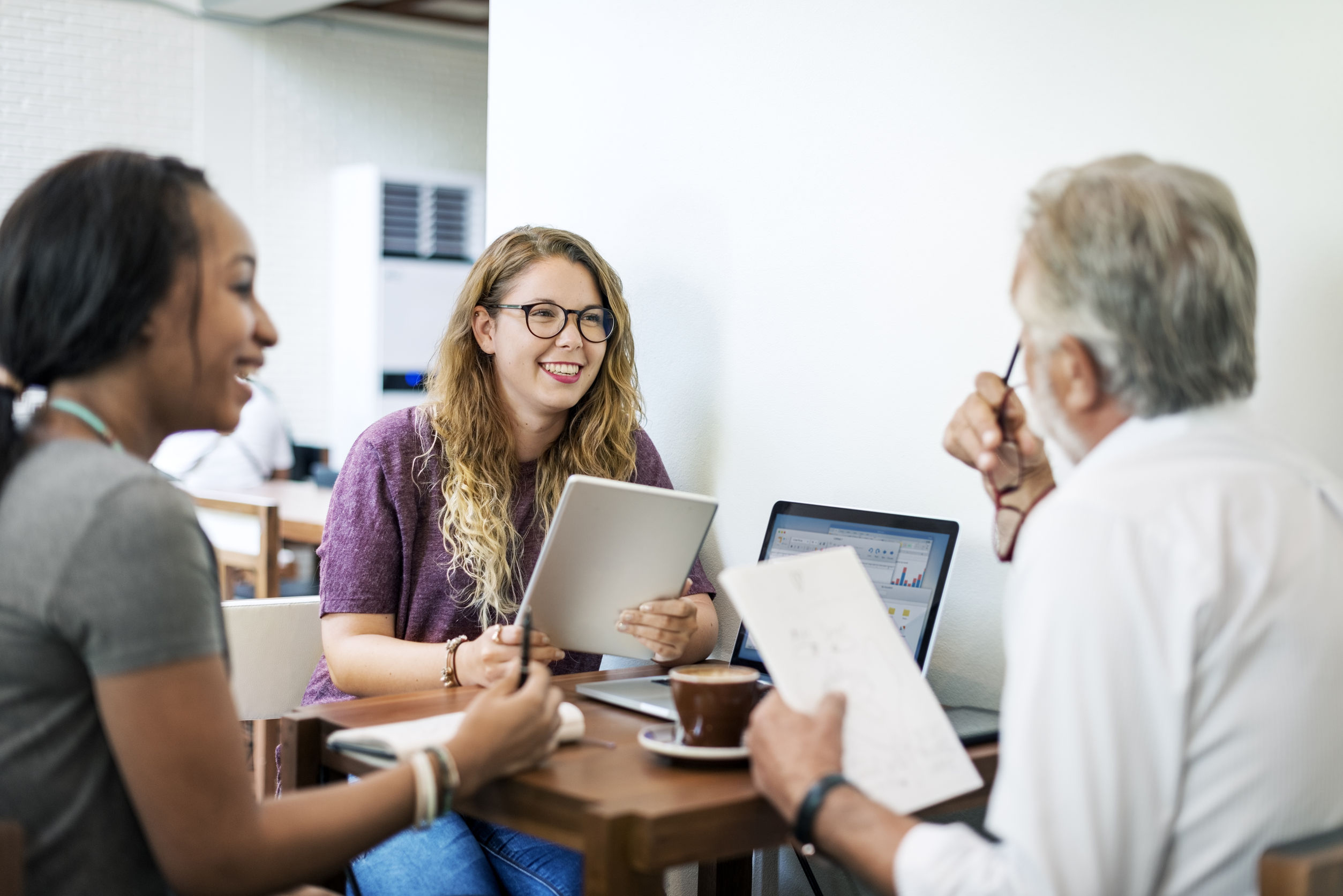 man speaking to two college students