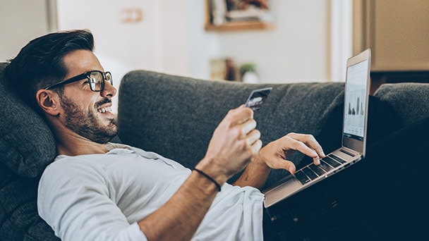 Person with credit card and laptop