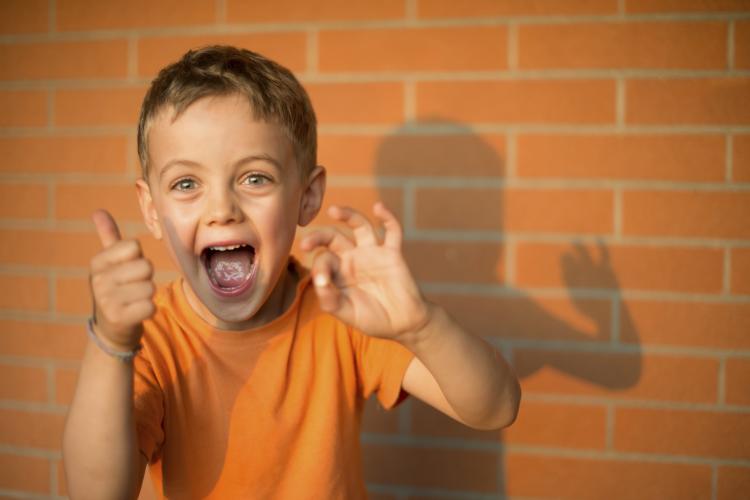 Happy kid giving a thumbs up.