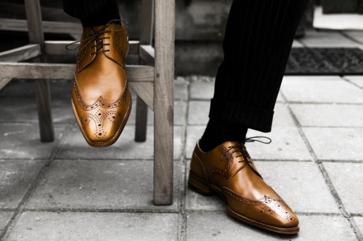 Man wearing fancy brown shoes.