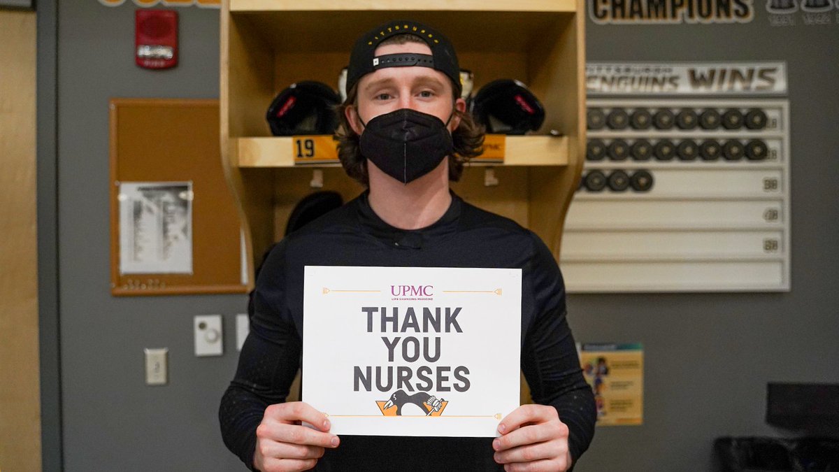 McCann holds up sign that says "Thank You Nurses"