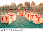 wedding arch, chairs prepared on the shore of a beautiful lake for a wedding on a summer day. Стоковое фото, фотограф Акиньшин Владимир / Фотобанк Лори