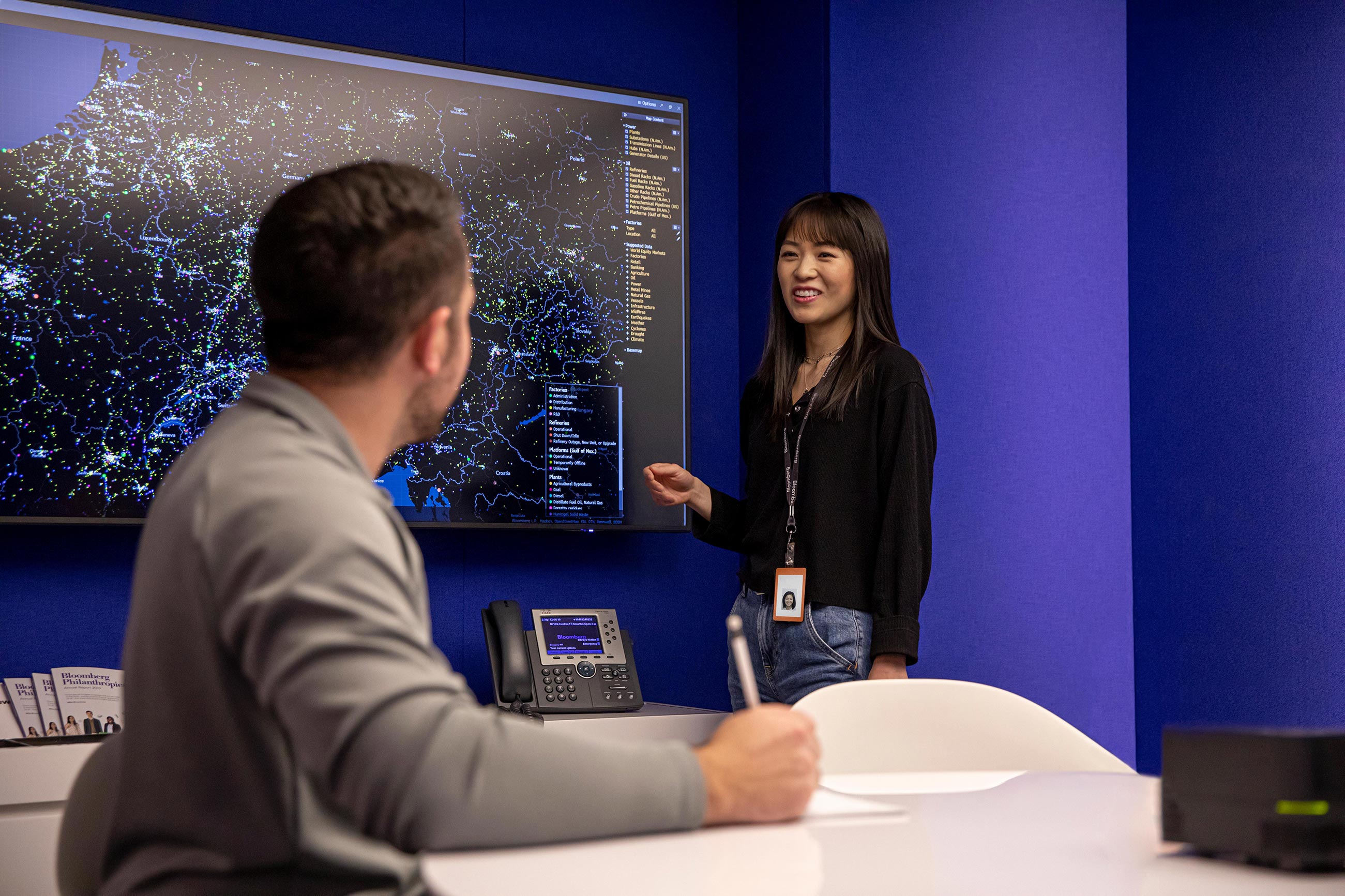 A Bloomberg employee presents to coworkers in a conference room at the Bloomberg offices.