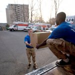 Moving company employees loading a moving truck