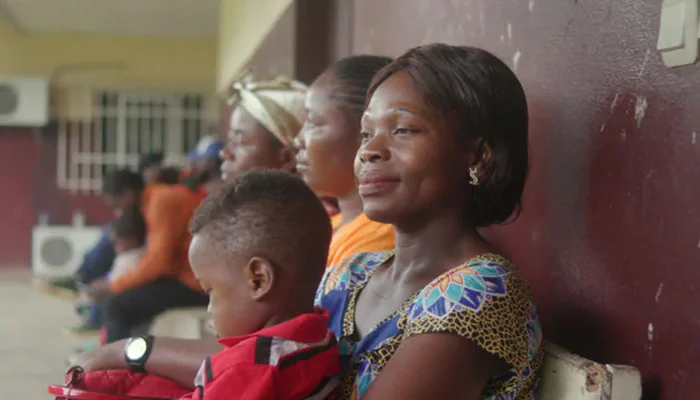 a woman holding a child in a waiting room