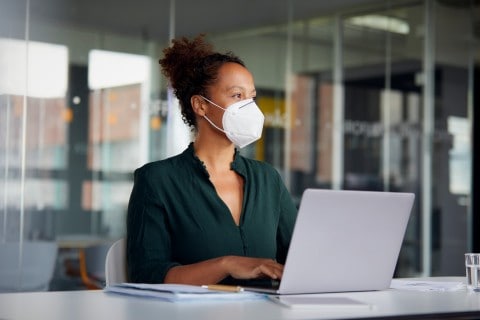 A woman wearing mask while working