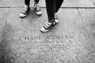 Sneakers standing next to the engraved pavement in the location of where Martin Luther King made his famous 