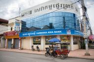 Bank with Western Union sign and tuk-tuk on the street in Siem Reap, Cambodia.