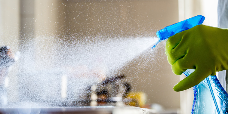 Spraying Cleaning Product on the Kitchen Counter