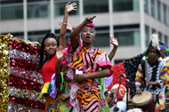 Children in colorful clothes wave on a float wave to the crowd during the annual Juneteenth parade in Philadelphia, Pennsylvania, on June 23, 2018.