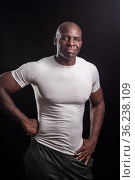 Portrait of a black man standing looking at camera with hands on waist. Стоковое фото, фотограф Iván Moreno / Фотобанк Лори