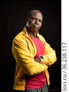 Portrait of a black man with crossed arms standing looking at the camera. Стоковое фото, фотограф Iván Moreno / Фотобанк Лори