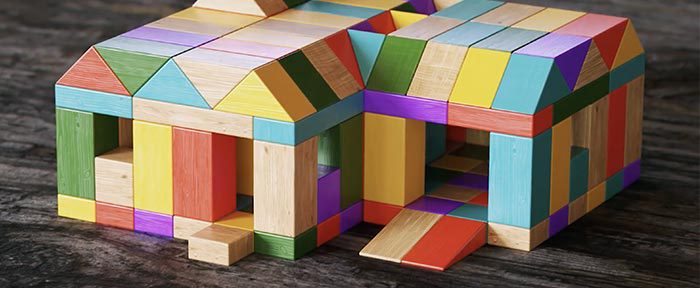 Small, multicolored structure composed of wooden blocks