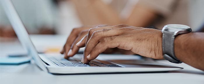 Hands on the keyboard of a notebook PC