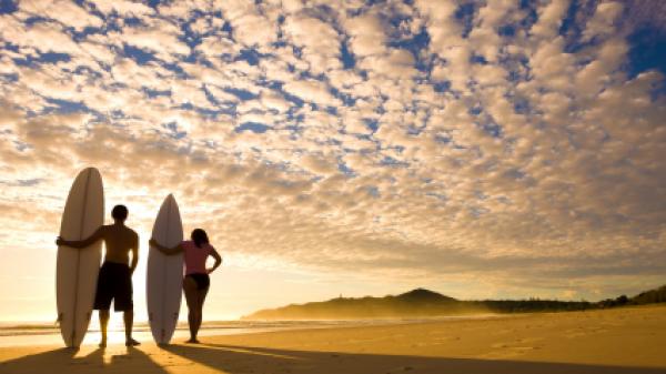 Two surfers at sunrise