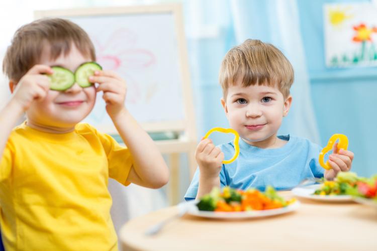 Two boys enjoying their vegetables on Eat Your Vegetables Day.