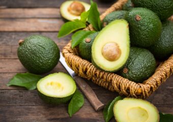 Fresh organic avocados on a wooden table.