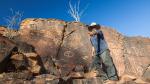 Aboriginal man at Chambers Gorge aboriginal engraving site in Flinders Ranges, South Australia.