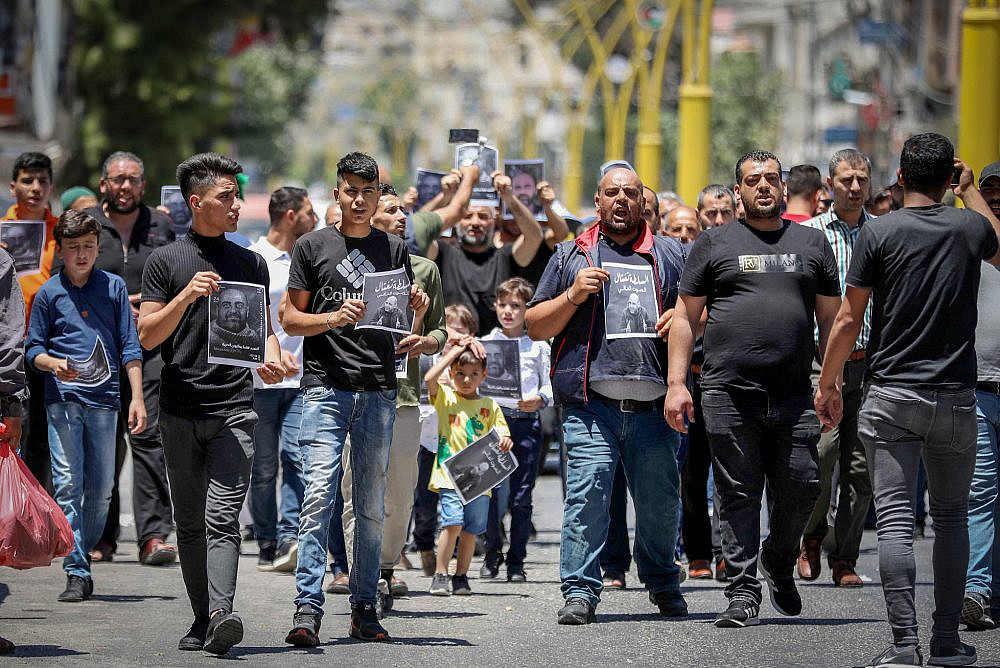 Palestinians take part in a protest over the killing of activist Nizar Banat, in the West Bank city of Hebron, July 2, 2021. (Wisam Hashlamoun/Flash90)