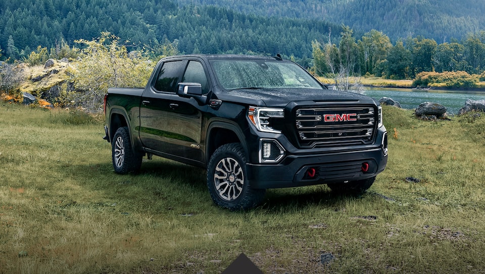 2021 GMC Sierra 1500 Denali Luxury Truck driving on bridge