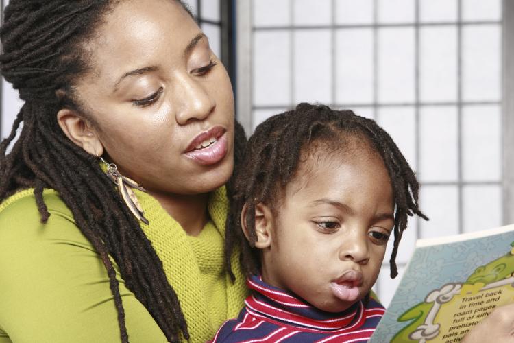 Mum reading a story to her daughter.