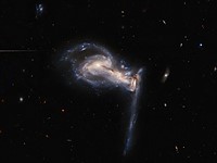 Hubble captures stunning gravitational interaction between a trio of galaxies